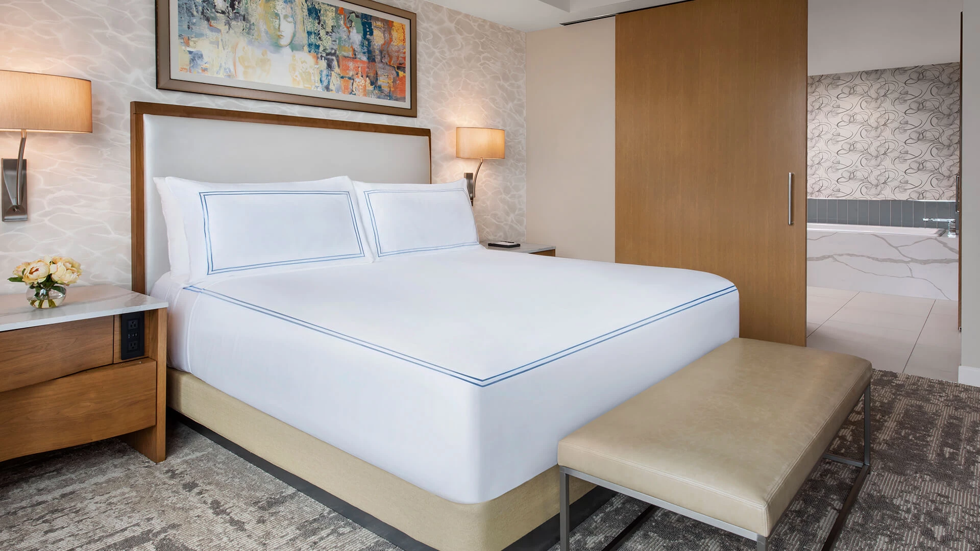 a bed with a lamp and a table