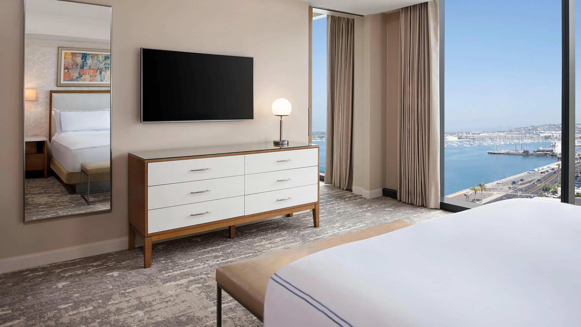 a bedroom with a television on the wall