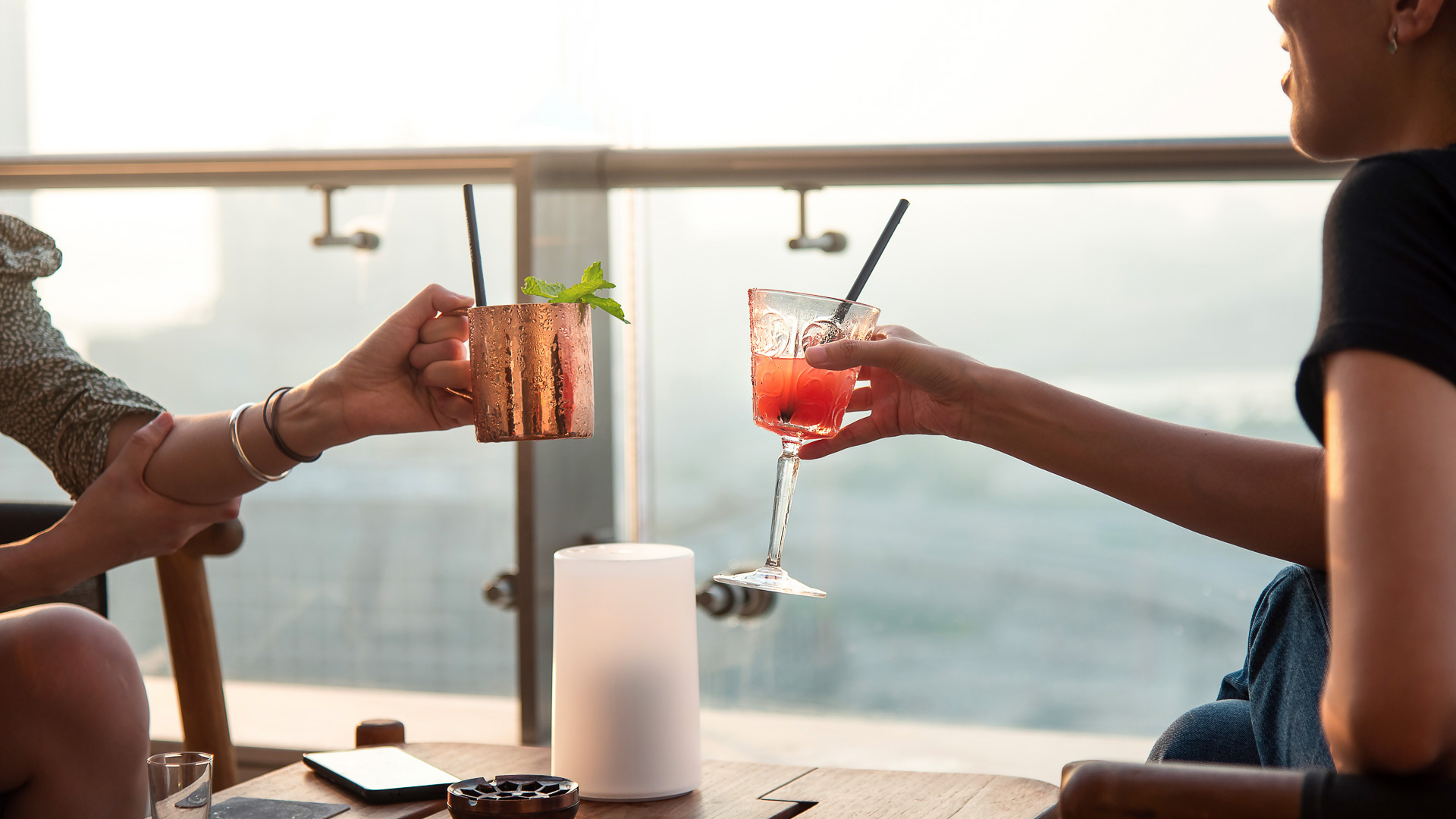 a pair of hands holding drinks