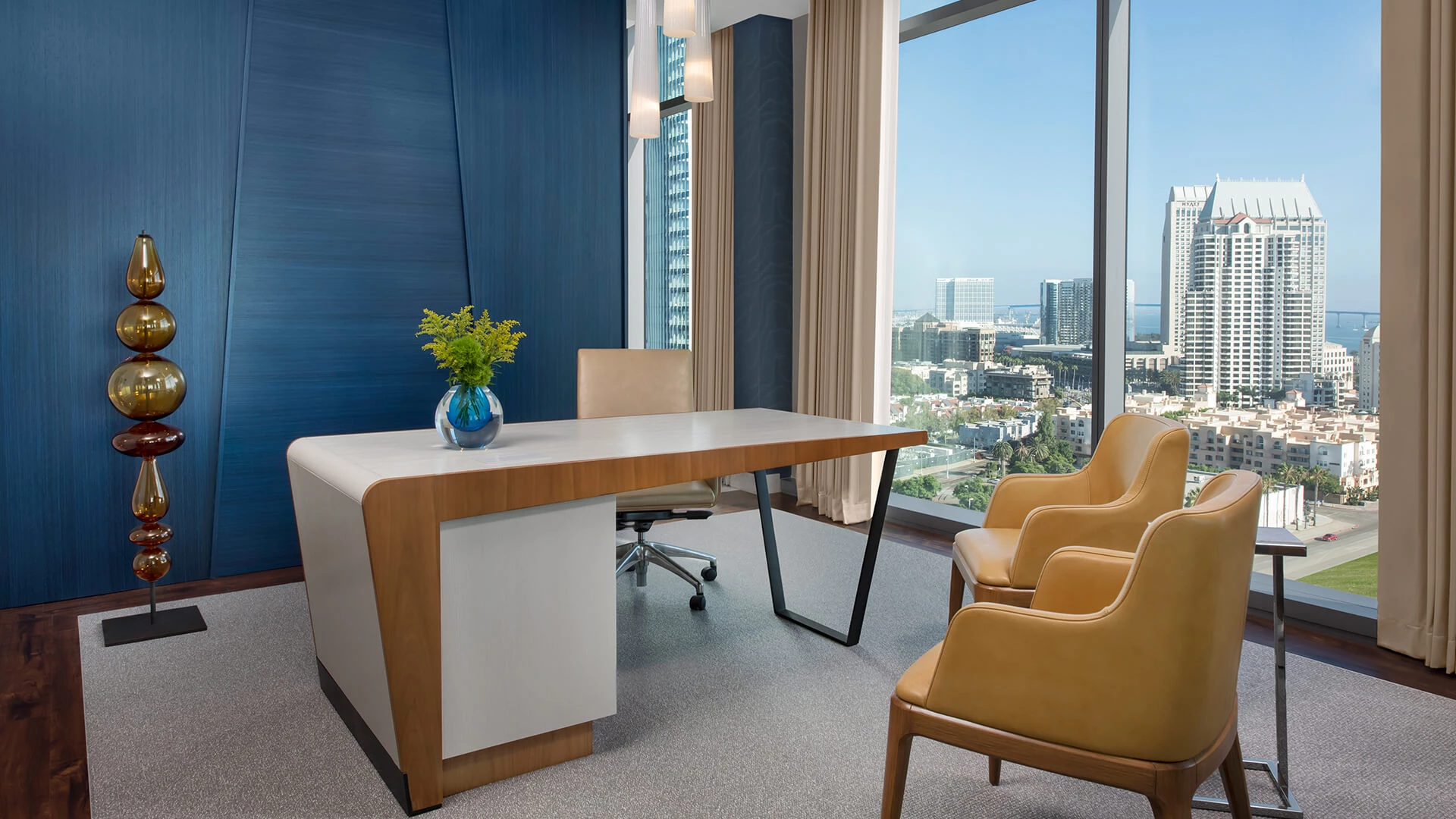 a room with a table and chairs and a window