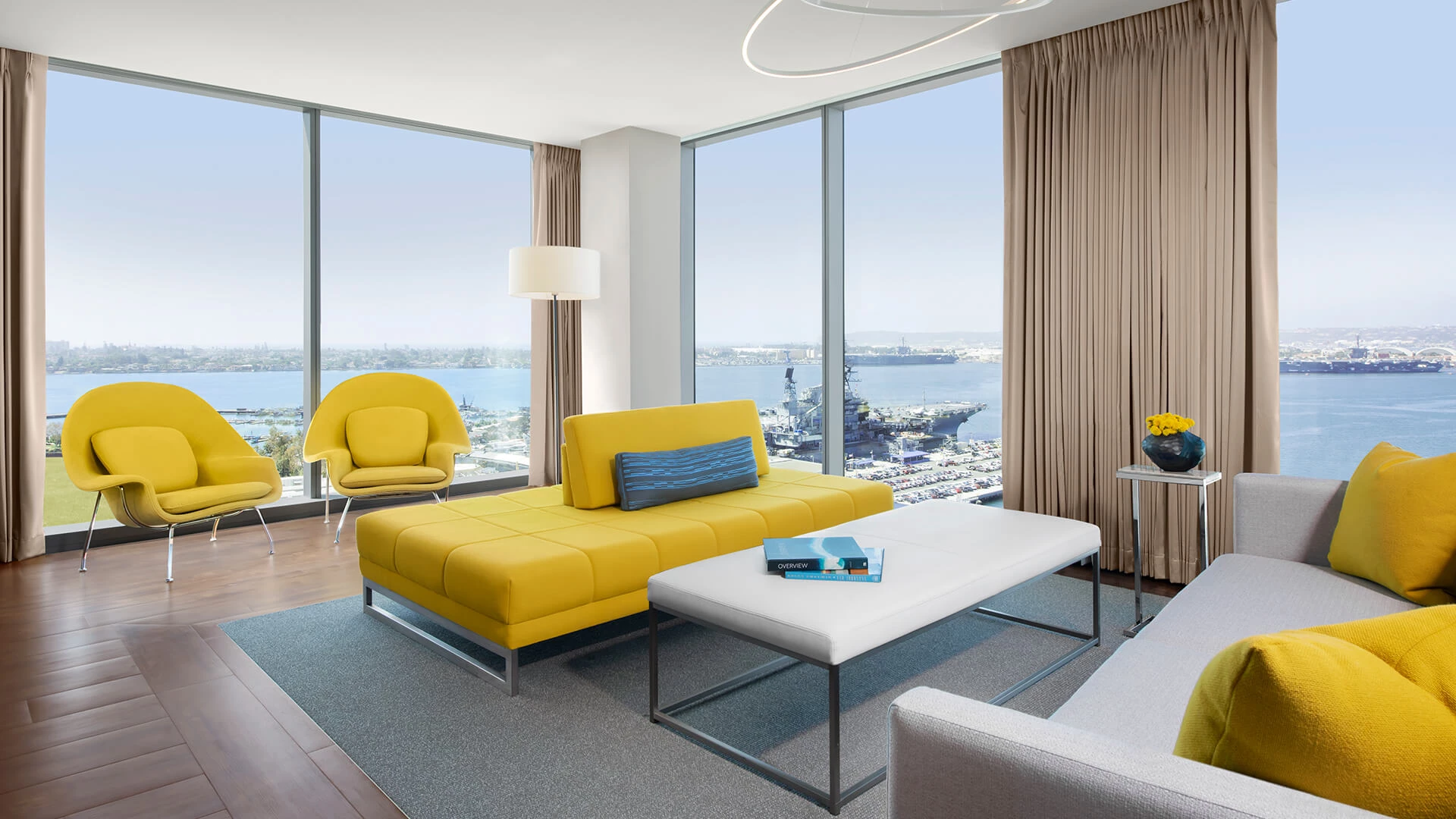 a living room with a yellow couch and a white coffee table