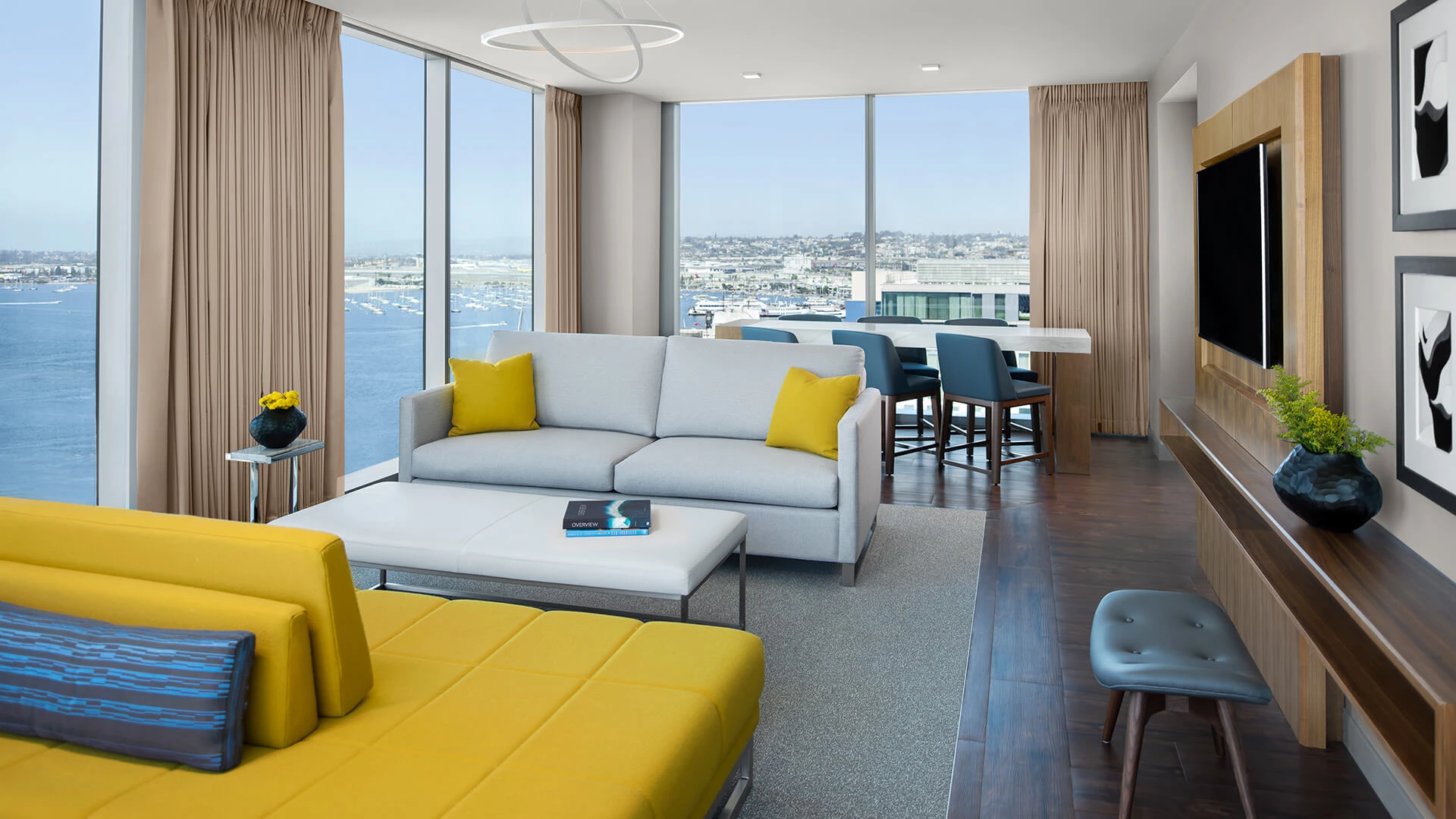 a living room with a view of the water and a city