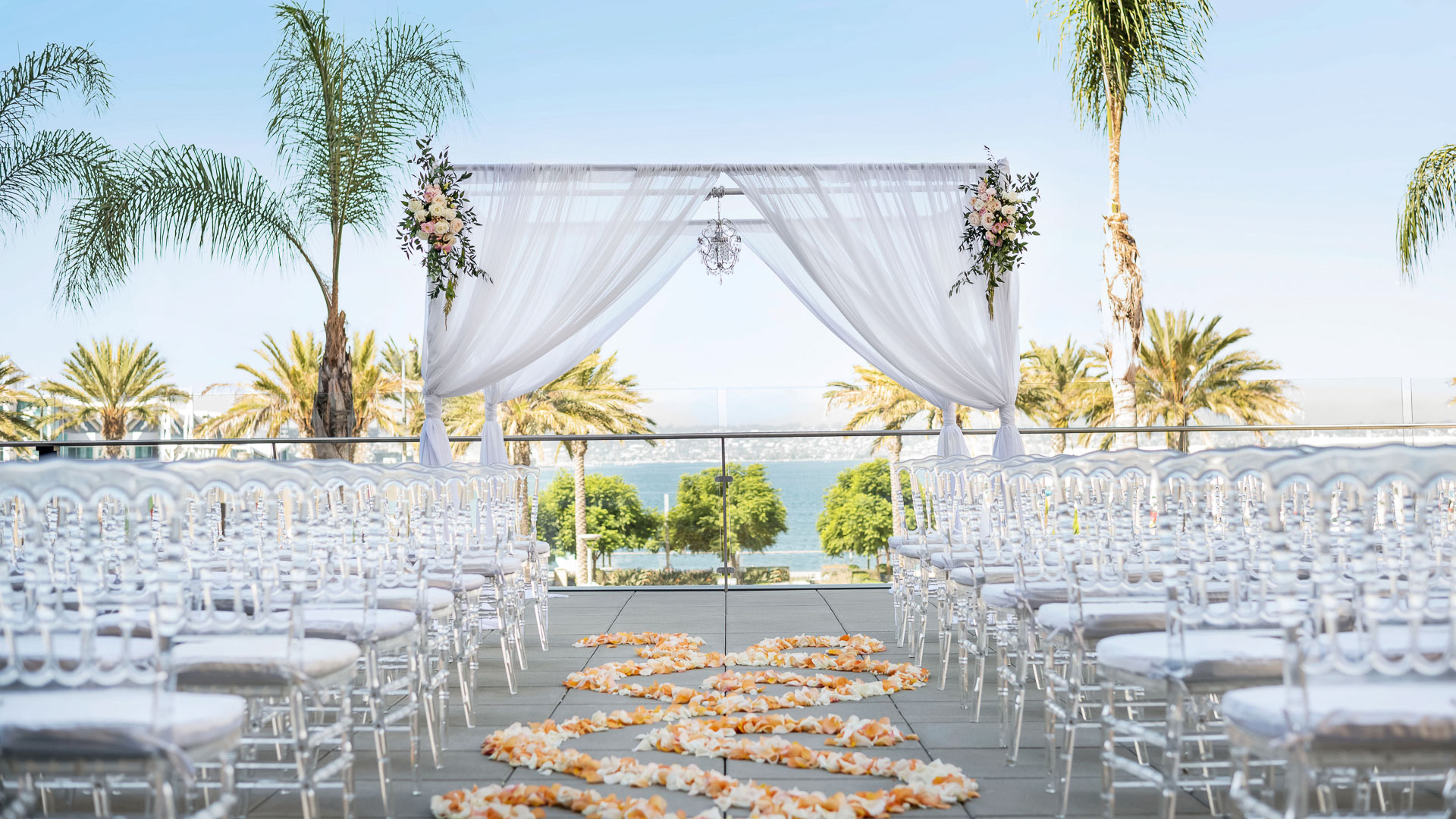 a wedding ceremony with chairs and flowers