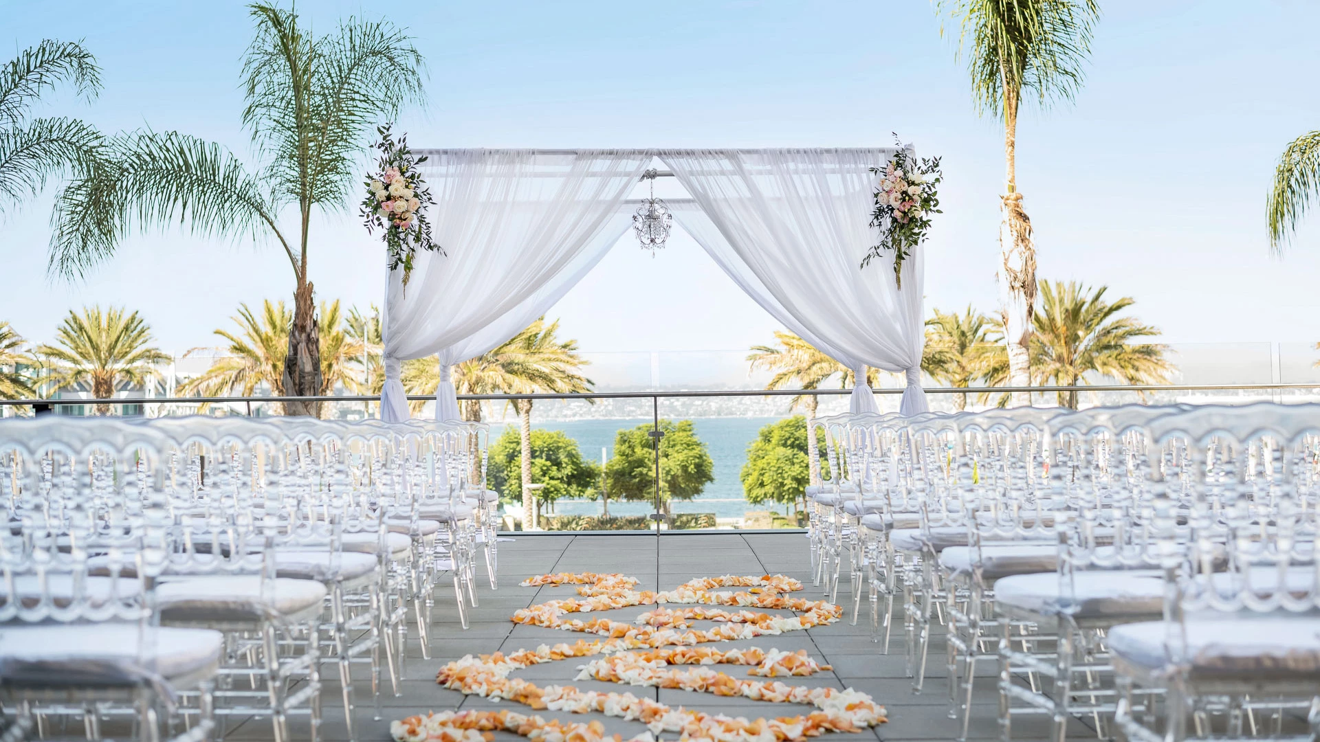 a wedding ceremony with chairs and flowers