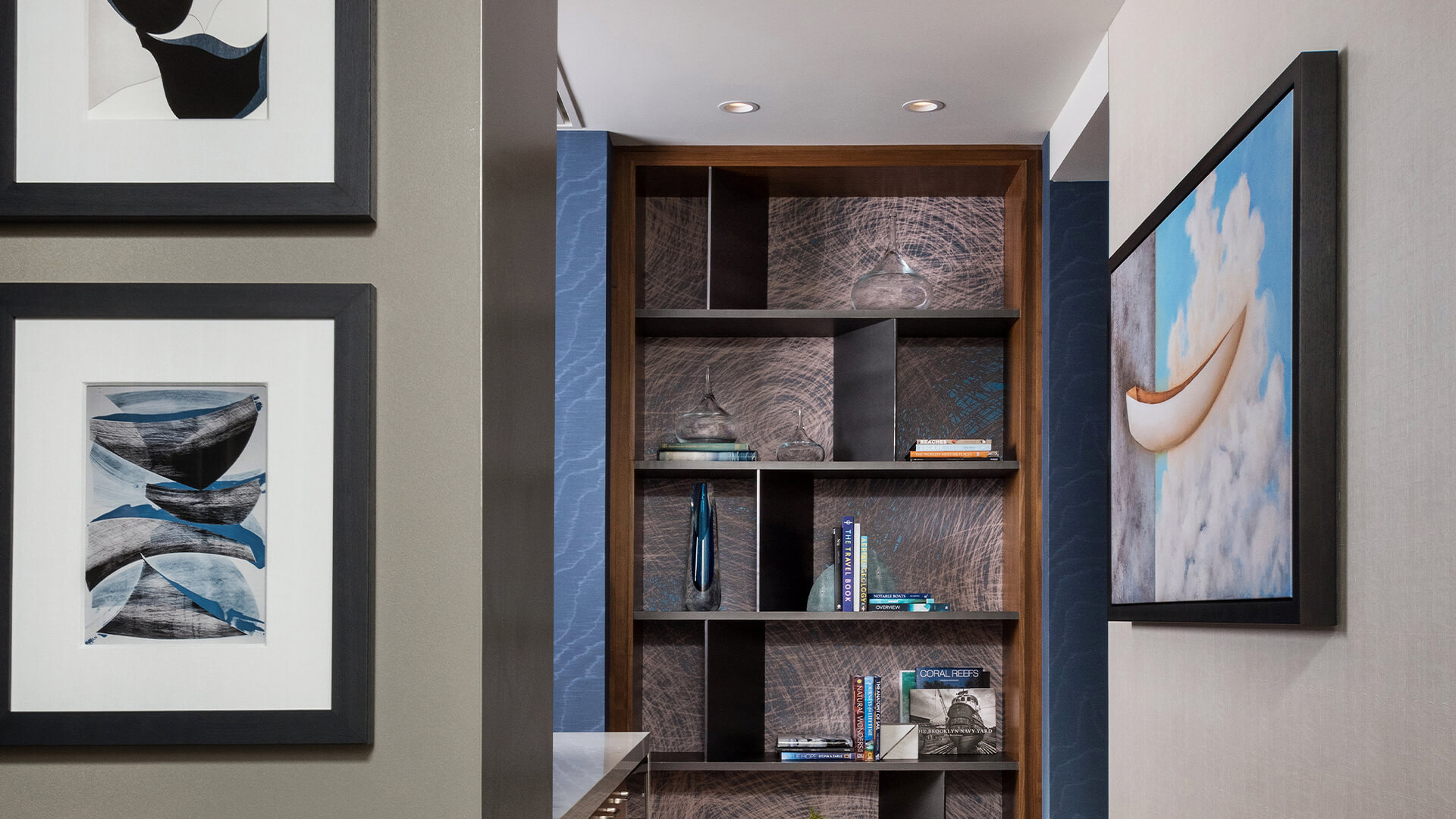 a shelf with books and a lamp
