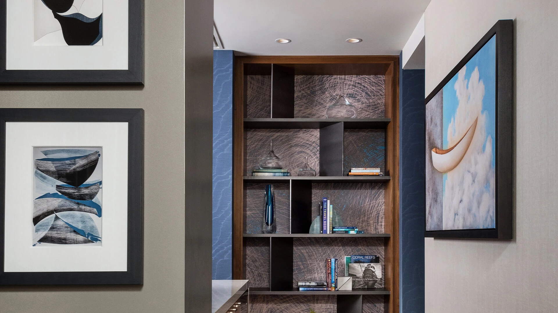 a shelf with books and a lamp