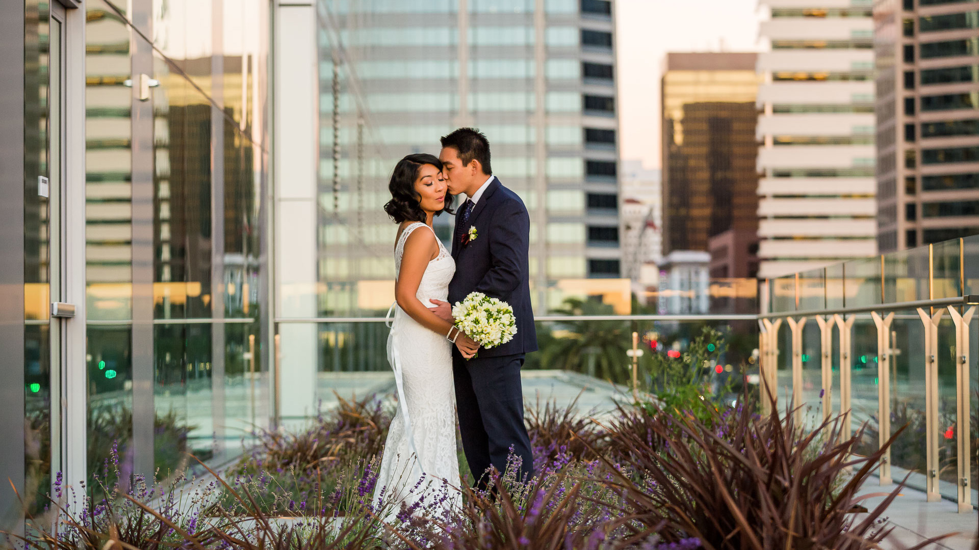 a man and woman kissing in front of a building