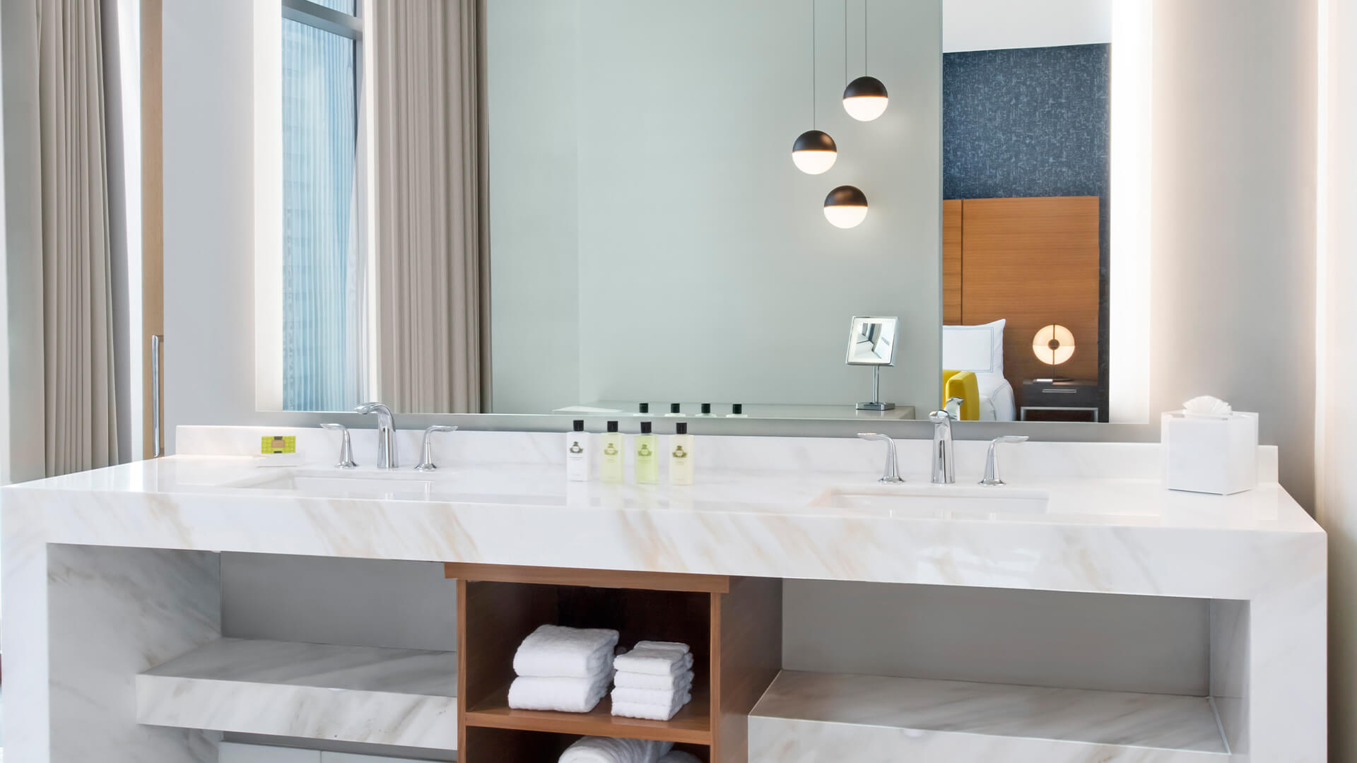 a bathroom with a large mirror and a large sink