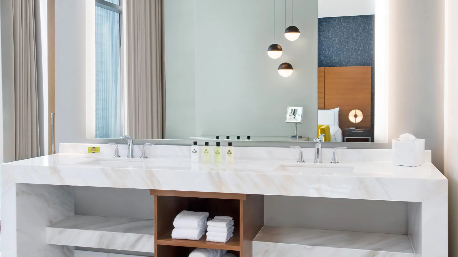 a bathroom with a large mirror and a large sink