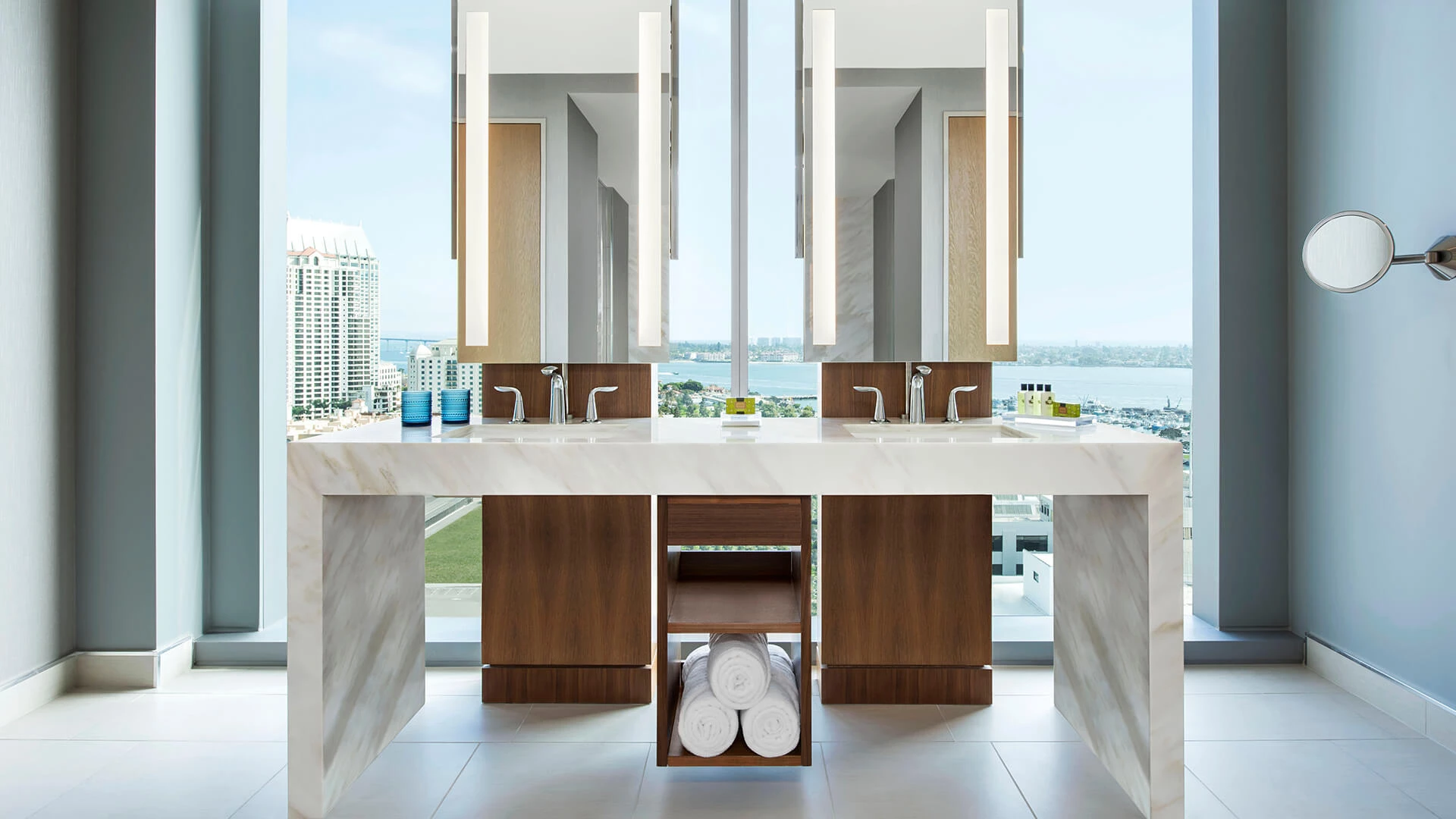 a bathroom with a large window overlooking a city