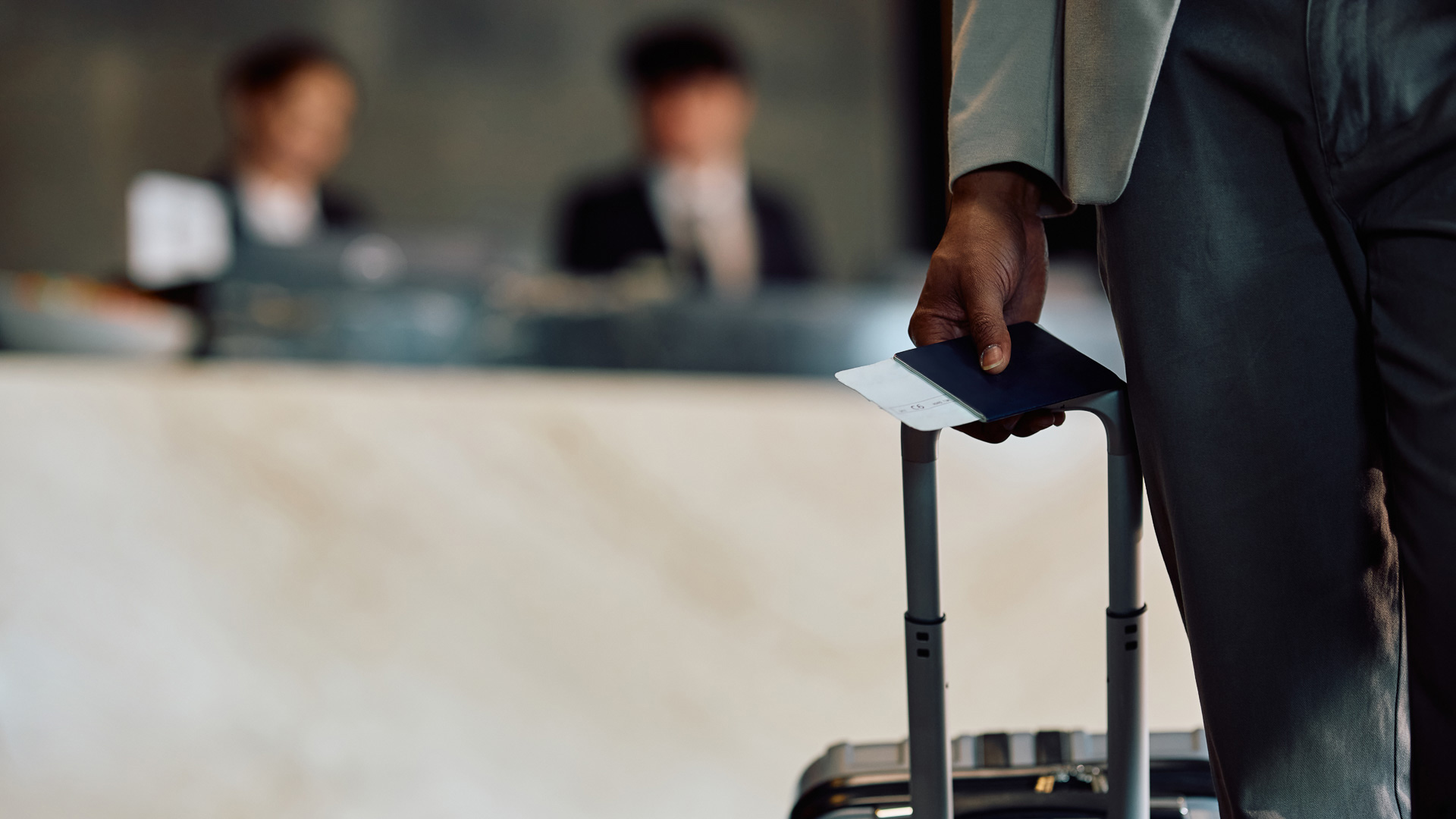 a person holding a passport and luggage