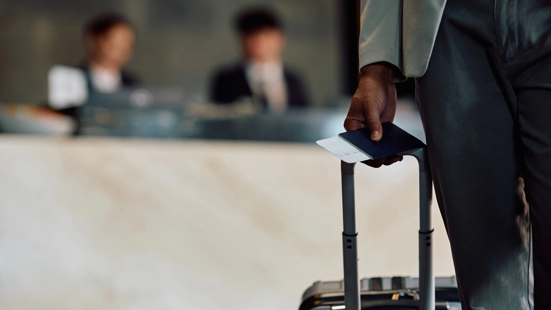 a person holding a passport and luggage