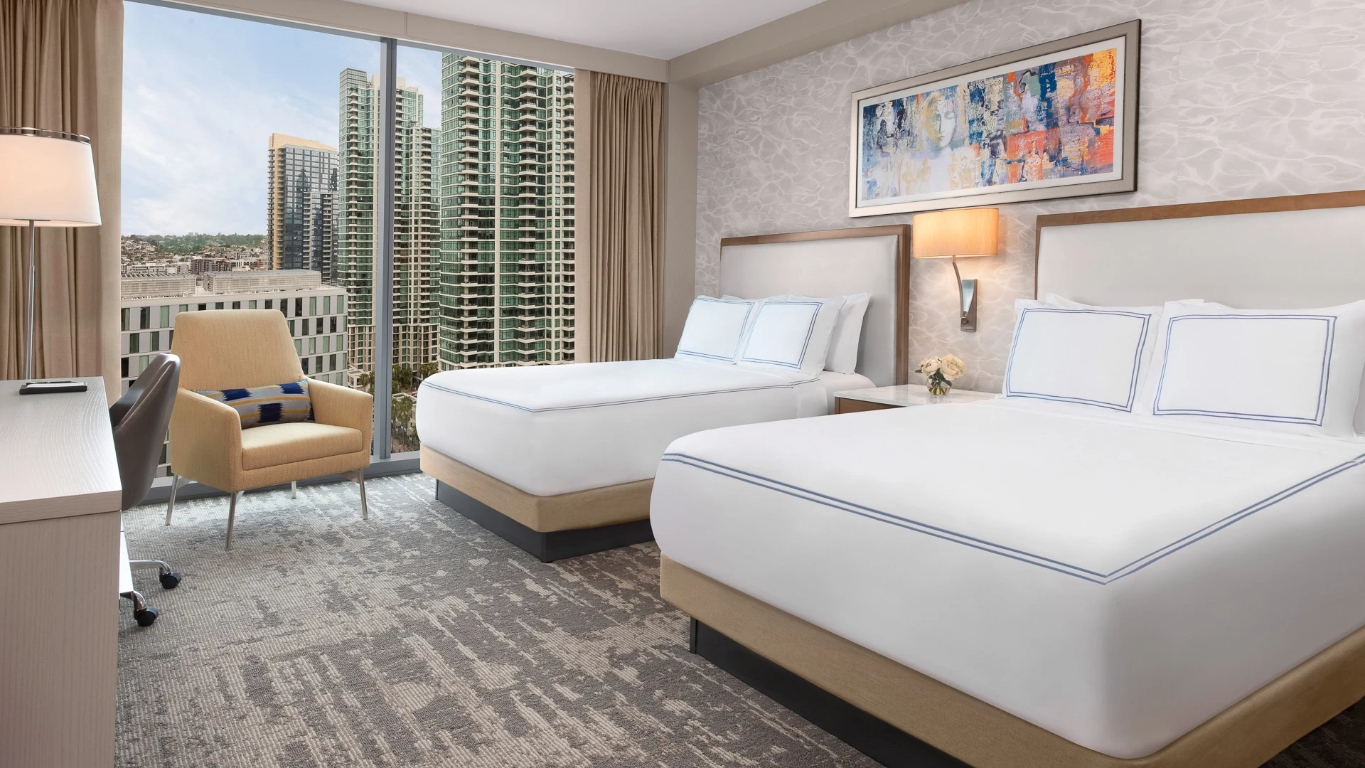 a room with two beds and a window