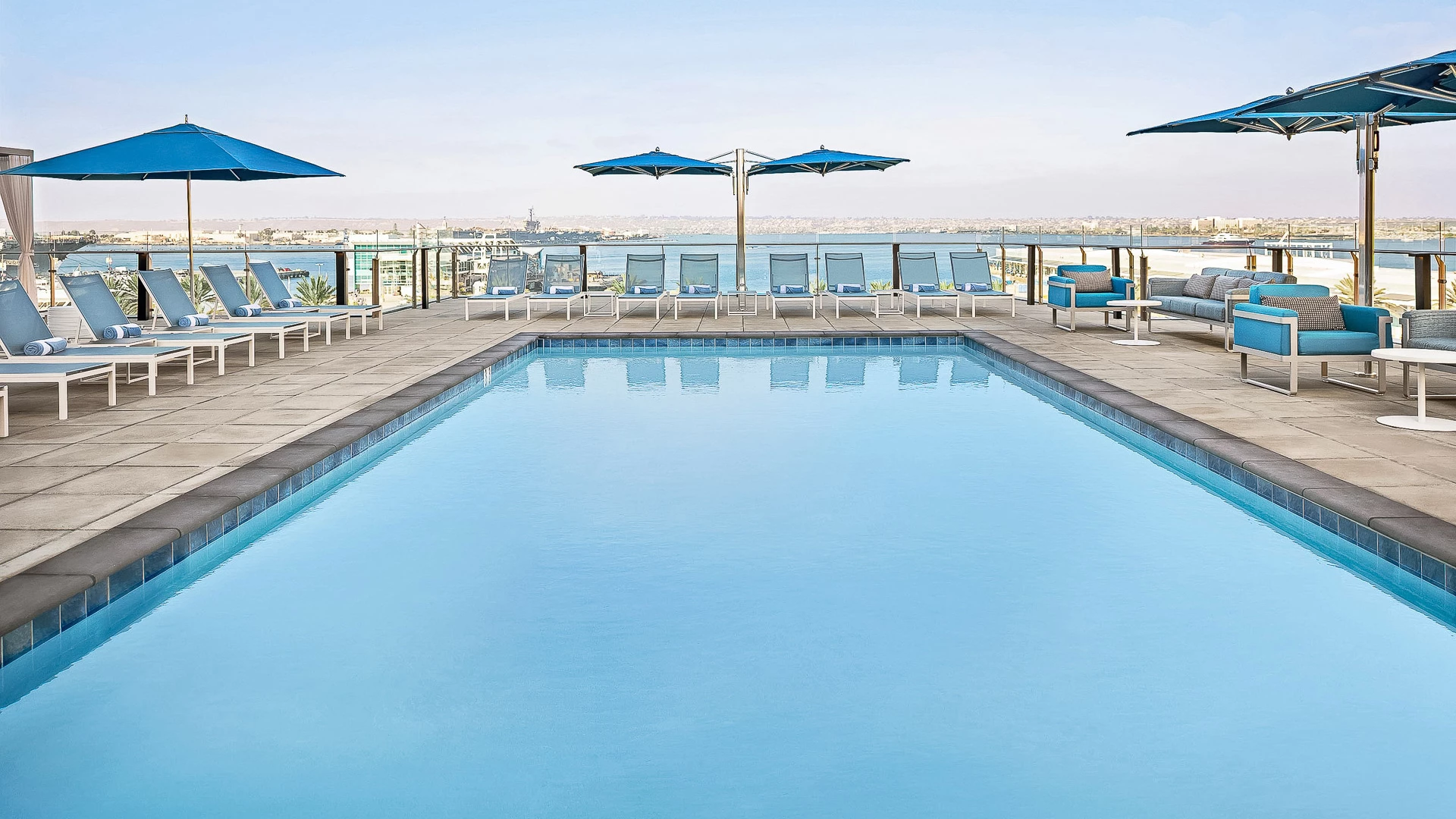a pool with chairs and umbrellas
