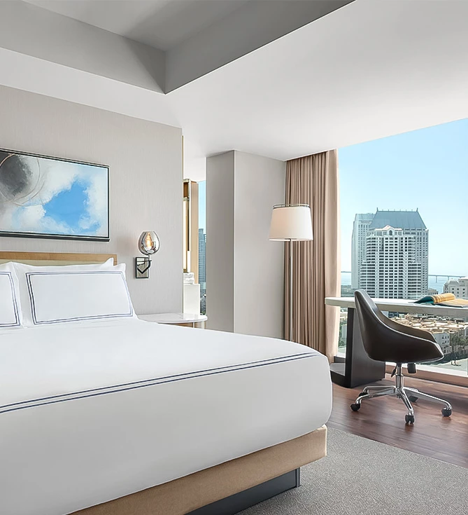 a hotel room with a large window and a large bed