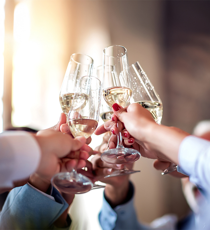 a group of people clinking wine glasses