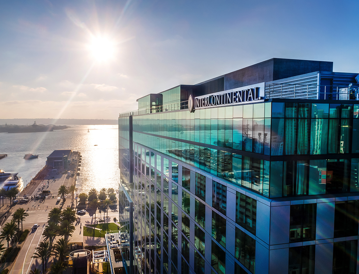 a building with glass windows and a body of water