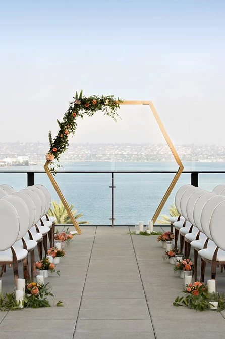 a wedding ceremony with chairs and flowers