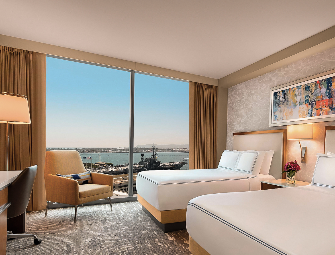 a room with two beds and a chair