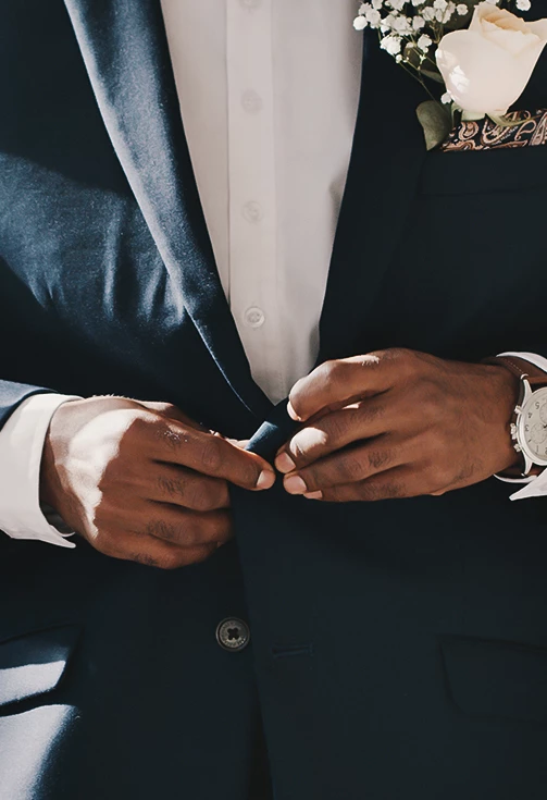 a man in a suit buttoning his jacket