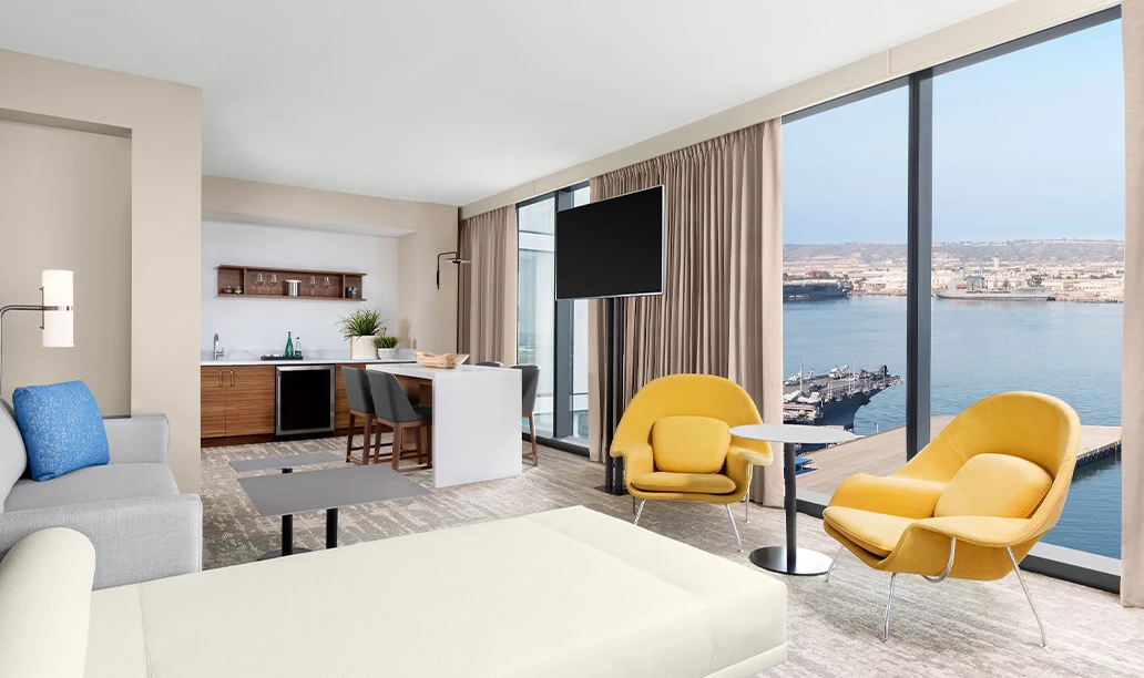 a room with a television and a view of the water
