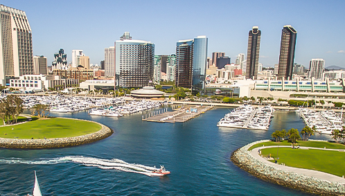 a city skyline with boats in the water