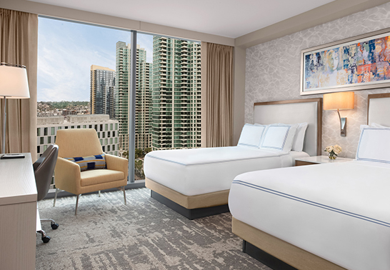 a room with two beds and a chair
