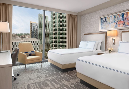 a room with two beds and a chair