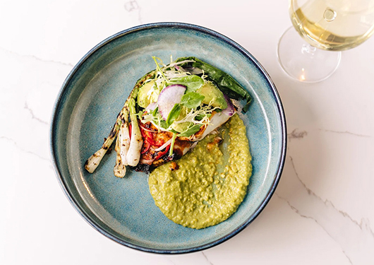 a plate of food and a glass of wine