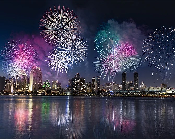 fireworks show over the san diego bay at night with view of the skyline