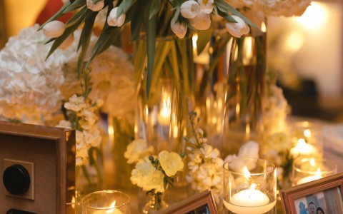 a group of flowers and candles on a table