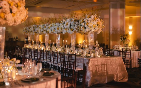 a long table with white and yellow flowers