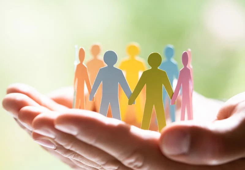 a close-up of a hand holding a group of people's hands