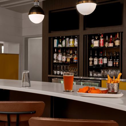 a bar with a plate of food and drinks
