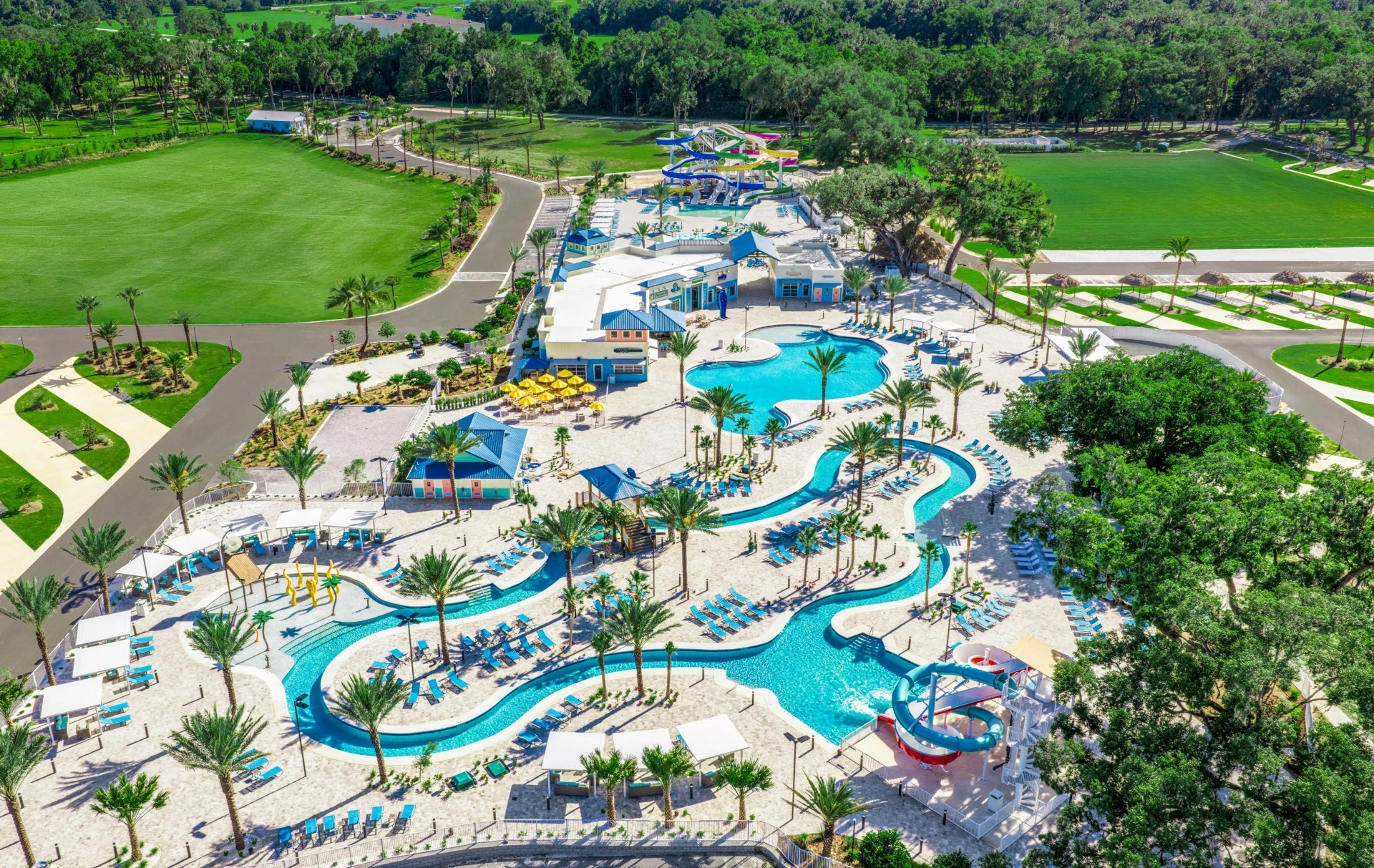 an aerial view of a resort with a pool and trees