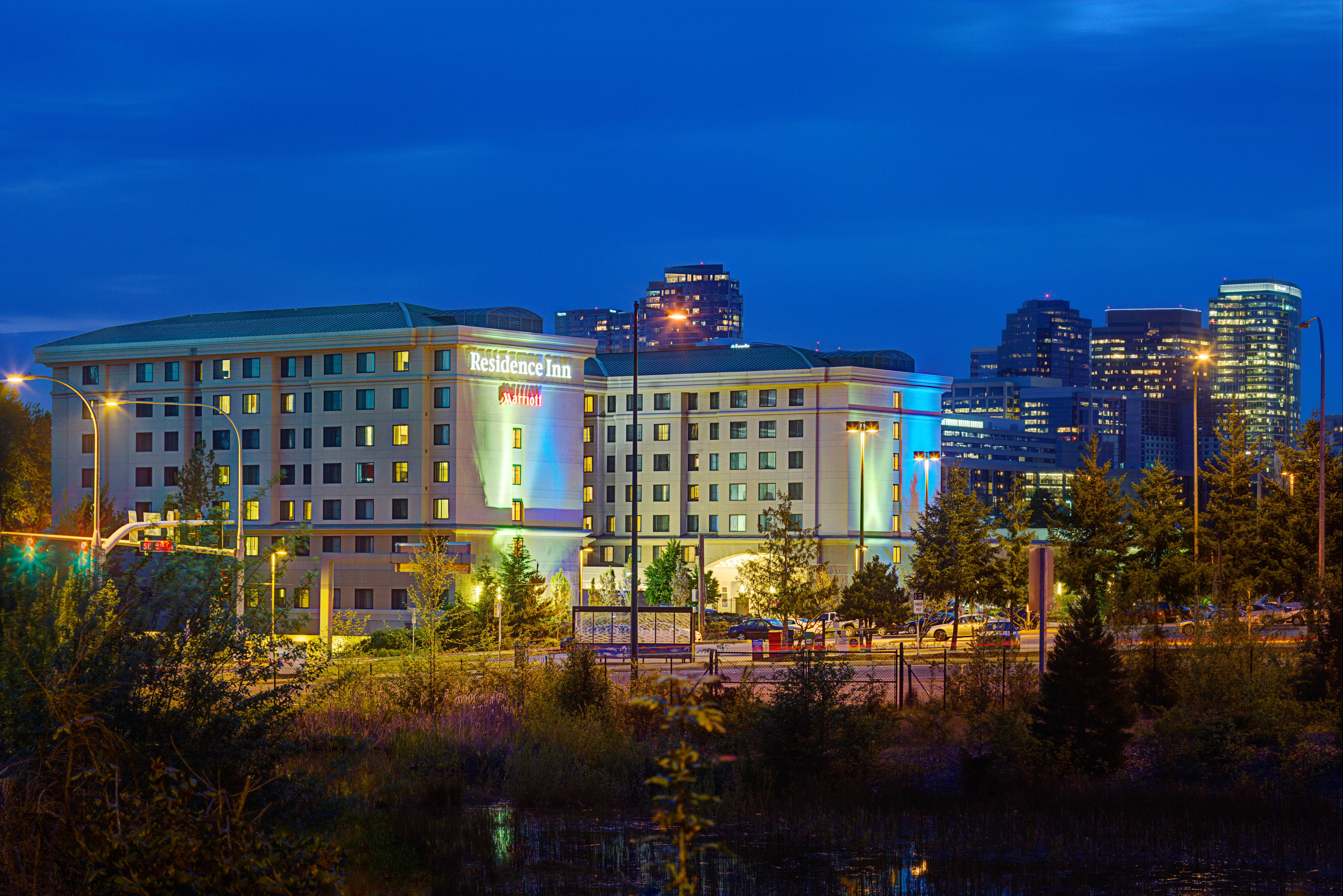 exterior of tall residence inn building at night in the distance