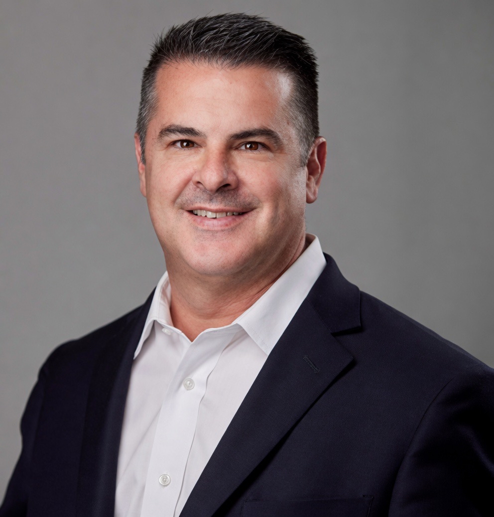 a man in a suit smiling