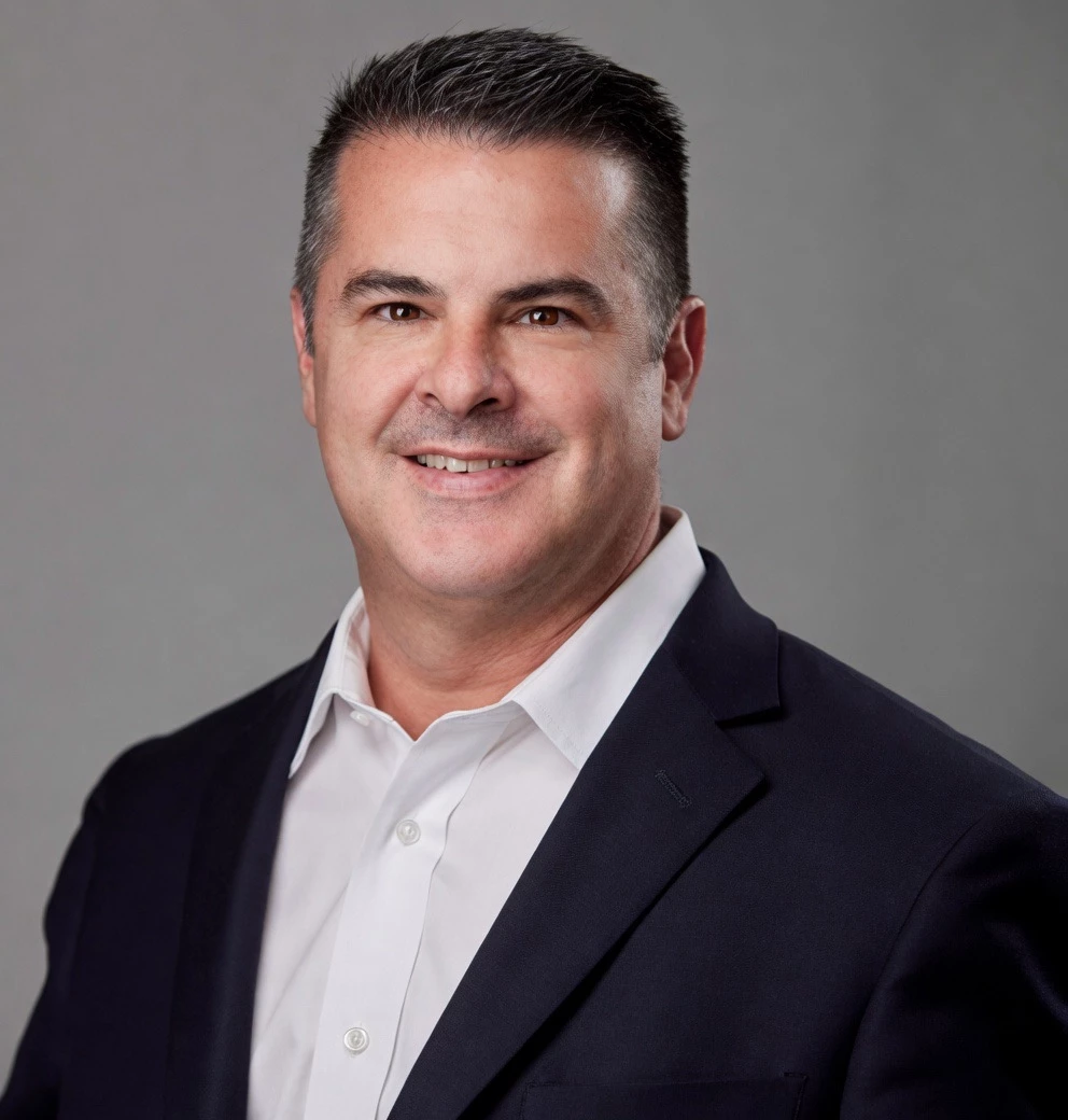 a man in a suit smiling