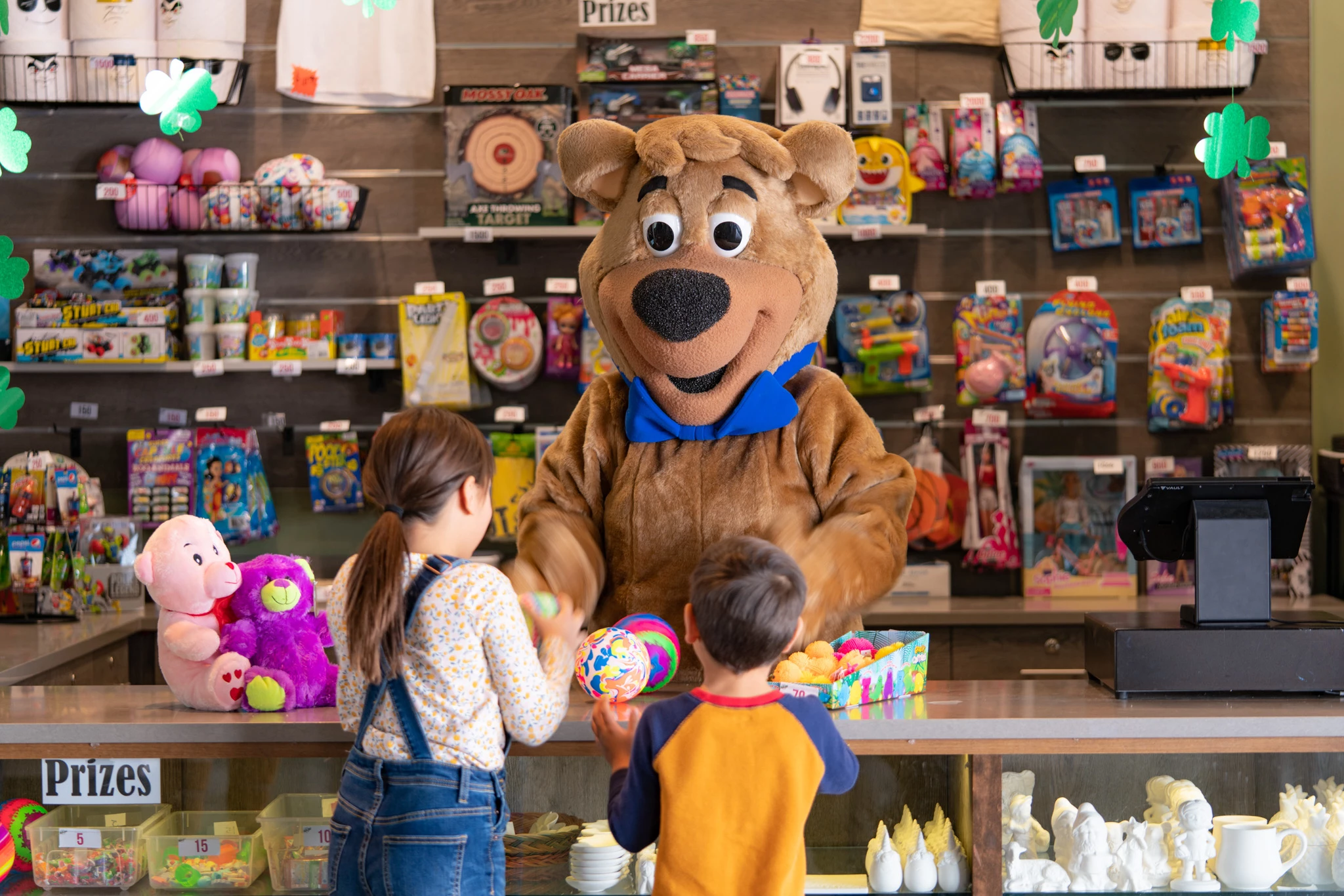 a person in a bear garment with a group of kids