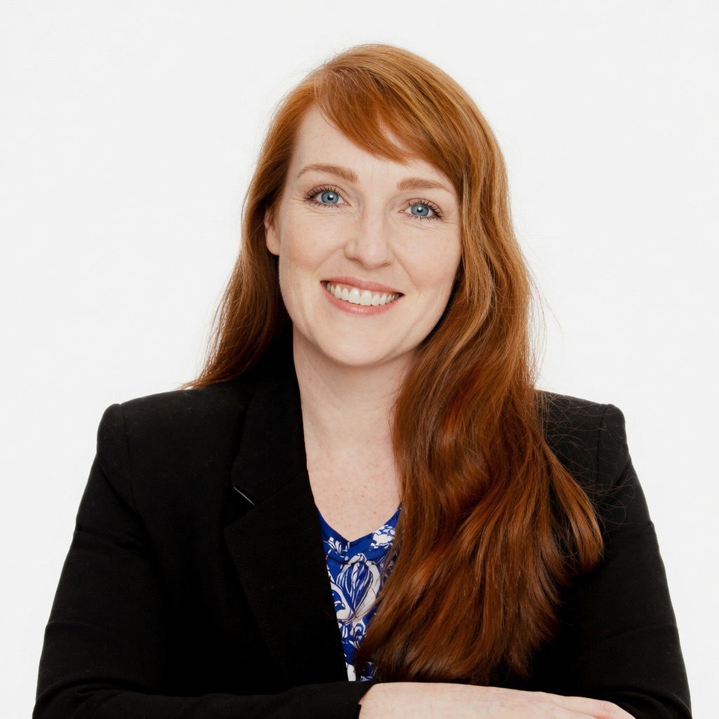 a woman with red hair wearing a black jacket