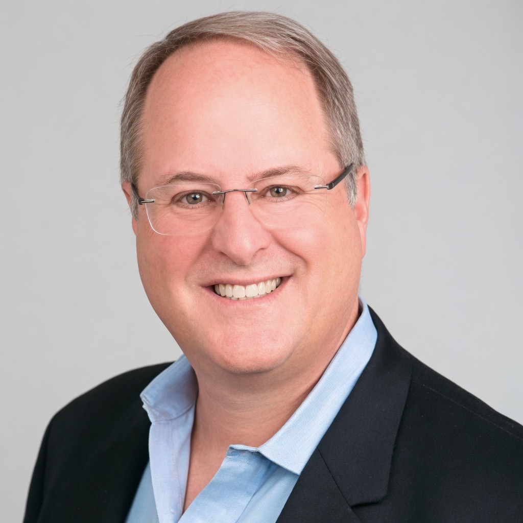 a man wearing glasses and a suit