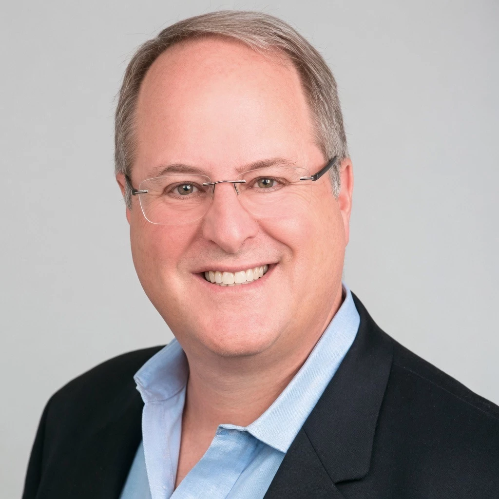 a man wearing glasses and a suit