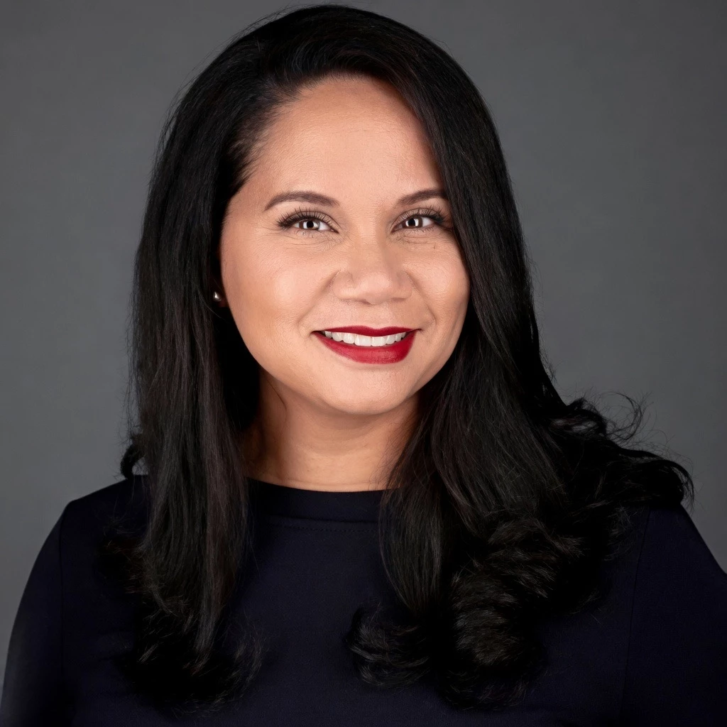 a woman with long black hair and red lipstick smiling