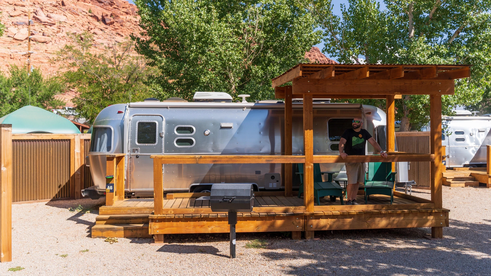 a man standing in front of a silver trailer