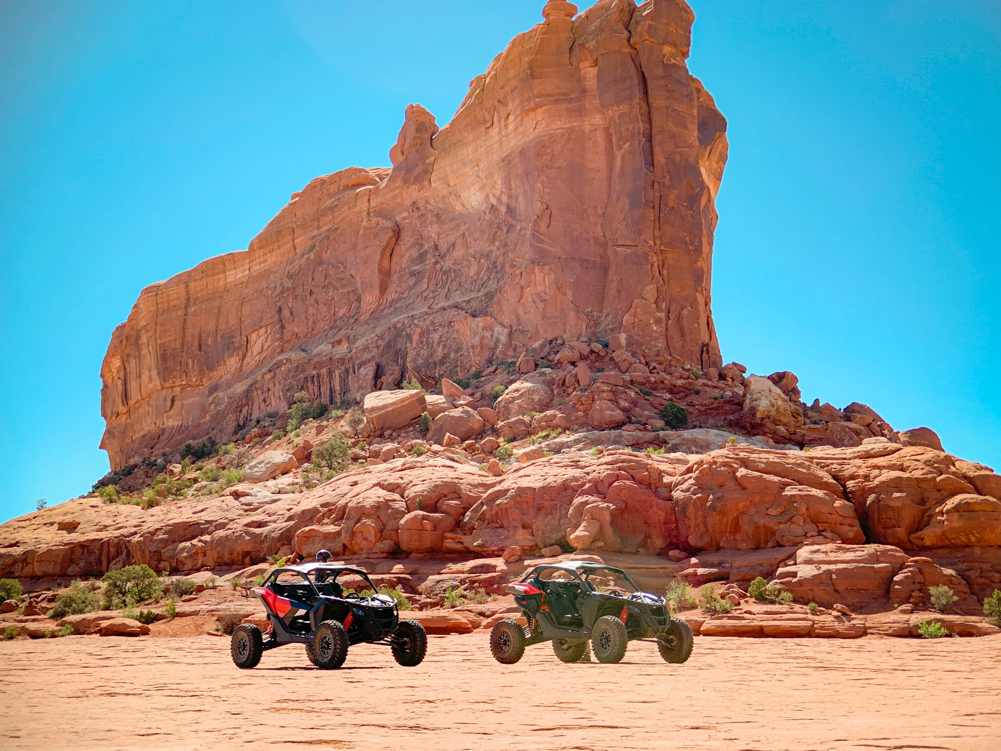 two vehicles parked in a desert