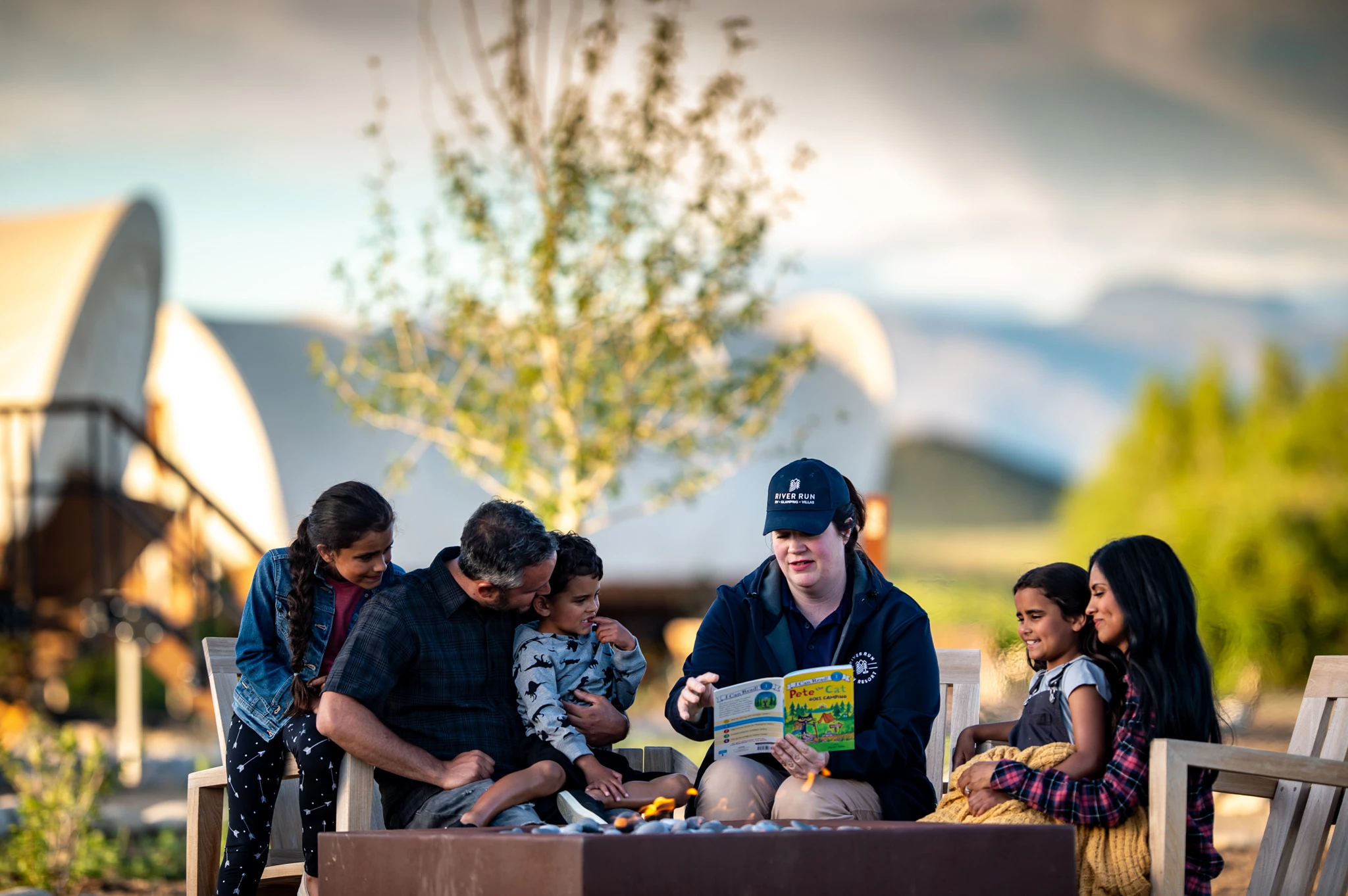 a group of people sitting around a fire pit