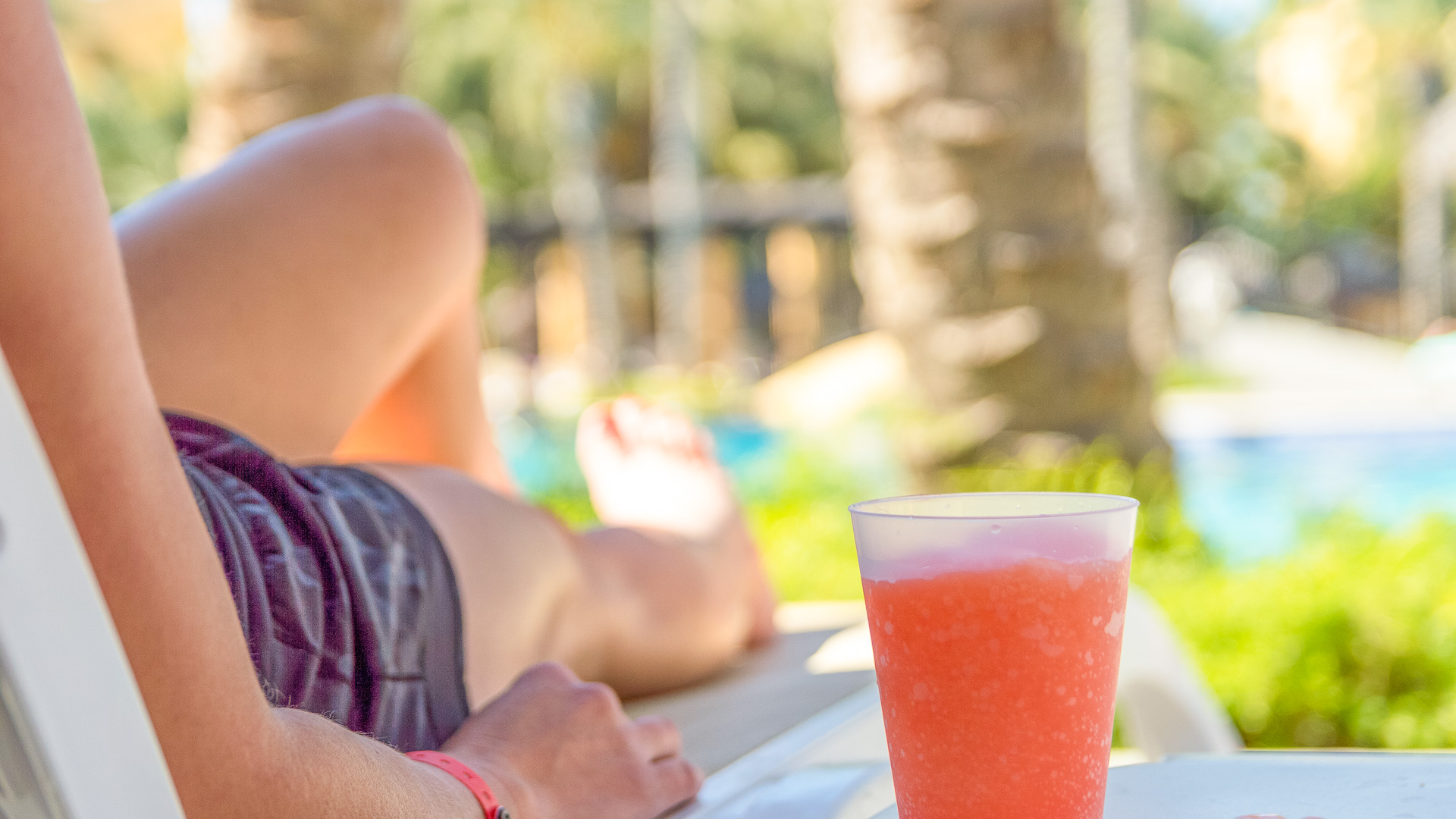a person lying on a table with a drink