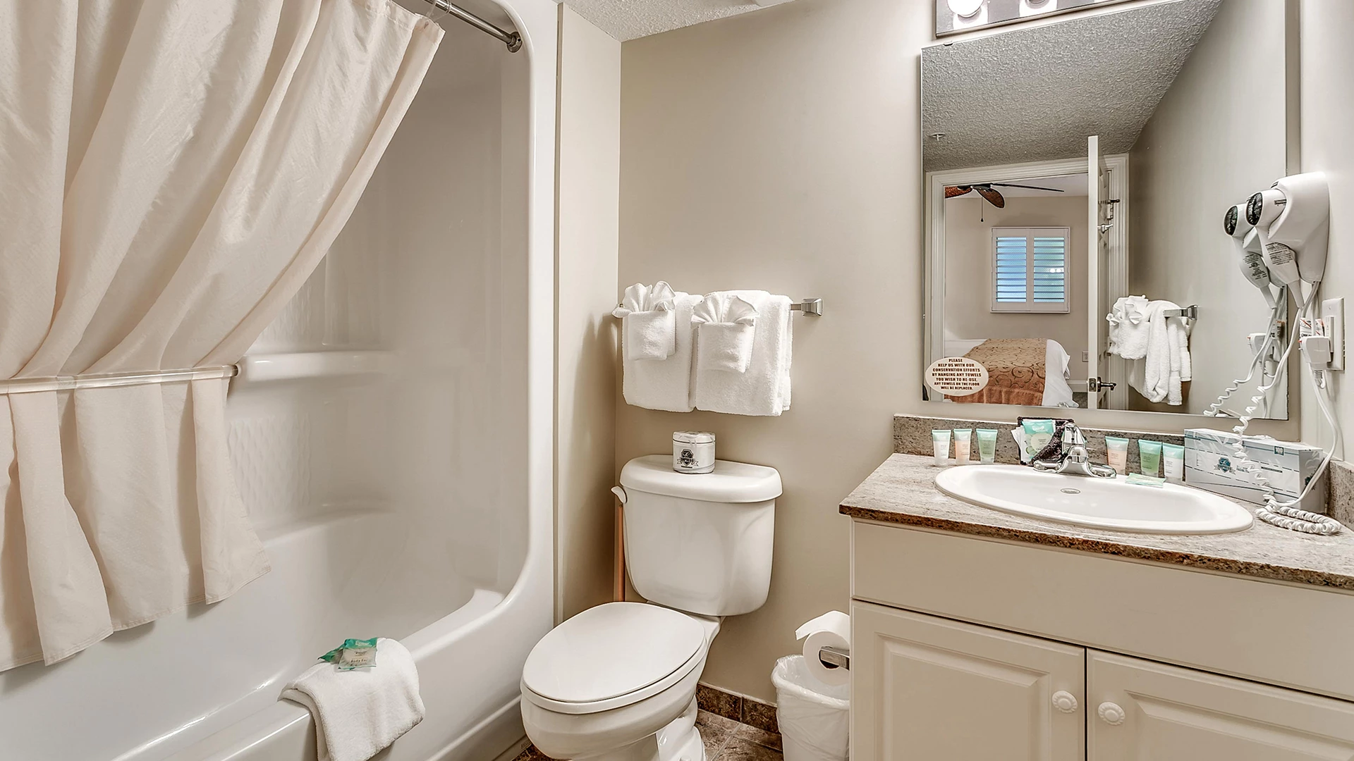 A bathroom with a bathtub, toilet, and sink