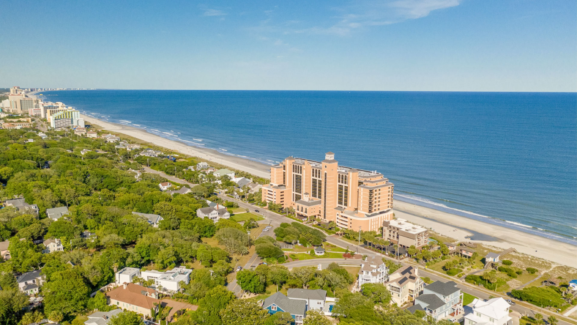 a large building next to a beach