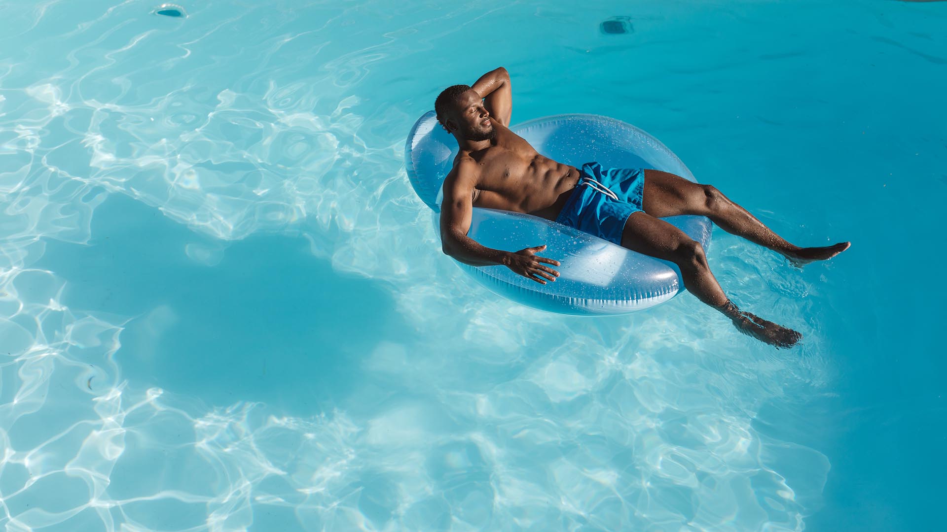 a man floating on a float in a pool